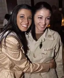 Miss New York USA 2004 Jaclyn Nesheiwat (left) visited U.S. troops in Iraq in March 2004.  While in Baghdad, she met her sister, Army Capt. Julie Nesheiwat (right)