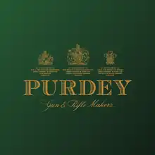 Purdey Gun & Rifle Makers in gold letters on a green ground surmounted by three royal warrants