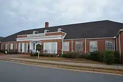 Photo of a red brick building with white trim.