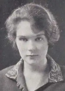 A young white woman; her dress or blouse has a print collar