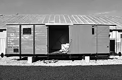 Photograph of a restored train car, with its sliding door open, used to transport Slovak Jews