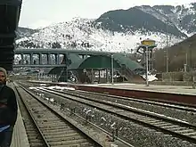 Station with overhead walkway and mountains in the background