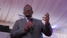 Keriako Tobiko holding a microphone and talking