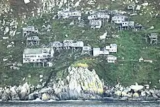 Ugiuvak, abandoned Inupiat stilt village, in 2010. The large white building near the bottom of the slope is the former Bureau of Indian Affairs school.