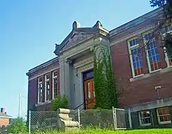 Front view of library showing main entrance, front facade and fencing