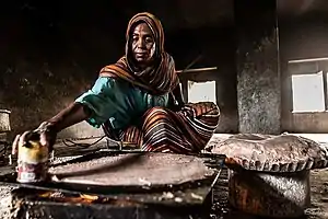 A woman preparing kisra