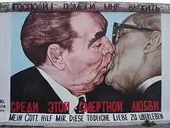 Graffiti of two communist leaders kissing, on the Berlin Wall