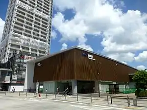 A sunny blue sky is behind a stylish new station building.