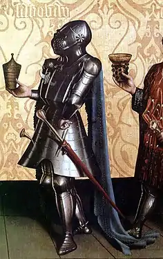 Knight wearing a great bascinet. The strap fixing the helmet to the breastplate is visible as is the impossibility of rotating the helmet. German painting of 1435, by Konrad Witz