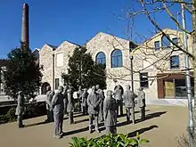 Colour photo showing Kresen Kernow building with trees and statues outside