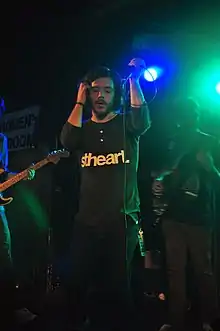 Travis performing with Dance Gavin Dance in 2010