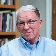 A head shot of Larry Crabb sitting at his desk