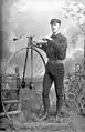 Laurie A. Perkins with a penny-farthing bicycle