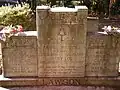 Headstone inscription reads "Not now, but in the coming years, it will be a better land, We'll read the meaning of our tears and then sometime we'll understand."