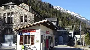 White single-story building with slanted roof