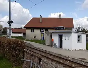 Single-story building with flat roof next to railway line