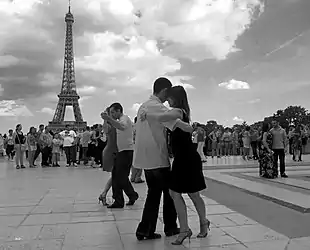 A gelatin silver print of 1989 from the collection REVOIR PARIS, the Trocadero square in Paris in front of the Eiffel Tower, a tango school invested the place - awarded at the Moscow photography contest in 2006