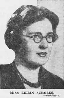 Black and white image of dark haired caucasian woman wearing glasses, lipsitck and a necklace