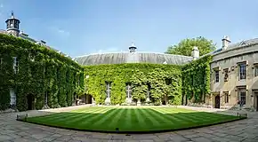 exterior of large old building, much of it covered with ivy