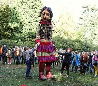 Little Amal with internal puppeteer on stilts, and puppeteers with rods, Barnsley, 2021