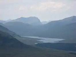 A lake in a narrow valley surrounded by mountains