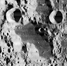 The dark, flat plain at the bottom is Schubert N.  At the top are the craters Respighi (upper left) and Liouville (upper right). From Lunar Orbiter 1.