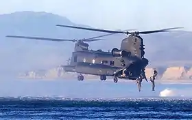 A 160th SOAR(A) MH-47 conducts water insertion of Marine Raiders