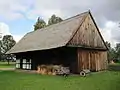 Board-on-board siding and half timber-framed barn in Olsztynek, north Poland