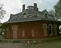 Brick house with, unusually, the timber frame second floor built into the roof structure. Gregg-Crites Octagon House in Circleville, Ohio (built 1855–56).