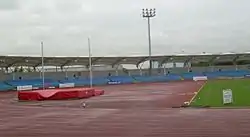 The Manchester Regional Arena, showing the running track, high jump apparatus and an empty stand.