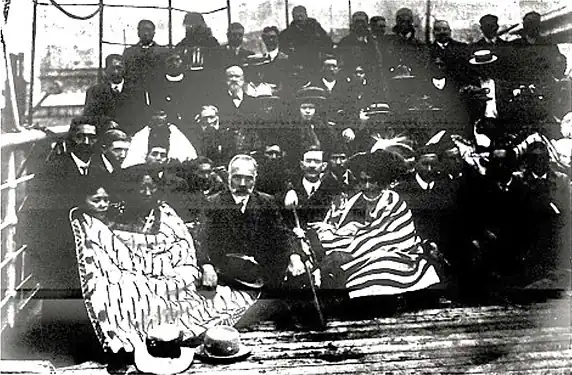 Press photo of a group of people aboard a boat.