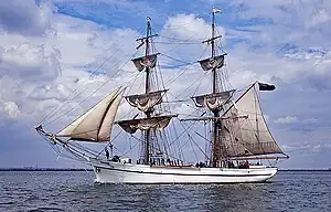 2 masted sailing ship with for and aft sails set