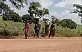 Ura women and children carrying things