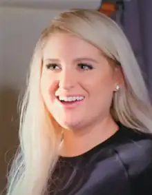 Meghan Trainor, a woman, smiling and looking towards the screen