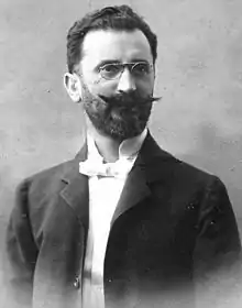 black and white portrait of a man with glasses and mustache