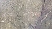 Inscription carved in rock wall at entrance to "bedroom": "DON'T !! WASTE WORRDS [OR] Jump to conclusions" It looks like the 2nd "R" in "WORRDS" was added later, that there is likely to be a missing "OR" (piece of rock probably fell off), and the 2nd part of the inscription was added later or by another hand.