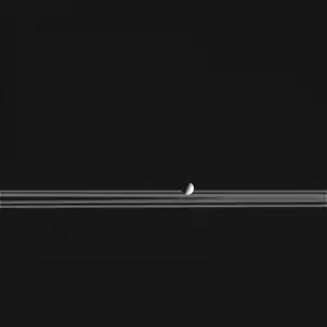 Cassini's image of Mimas passing in front of Saturn's rings, imaged on February 20, 2005.