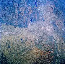 Photo of the region from space. Mountains can be seen throughout most of this picture.