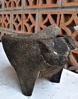 Tripod molcajete with a pig's head decoration, originating from San Salvador el Seco, Puebla, México; a very popular model in the taquerías (taco shops) of México City.