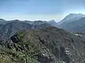 Mt. Tavagnone and its pastures of the former Battista Corsetti "Prandini" Fund, Dos di Sas and the Vein Pass on the far right, and ascending the ridge on the left three mountains, Mt. Gas respectively of 1,128 m., and two other unknown ones of 1,143 m., 1,067 m., while in the background the artificial lake of Valvestino, Mt. Pizzocolo, Mt. Castello and Lake Garda with the Sirmione peninsula.