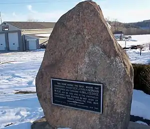 Granite stone standing in snow covered lawn. aluminum plaque on face of stone, raised letters read, "This stone marks the spot where the confederate raider John H. Morgan surrendered his command to Maj. George W. Rue July 26, 1863 and is the farthest point north ever reached by any body of Confederate troops during the Civil War. Erected by Will W. Thompson East Liverpool, Ohio1909"