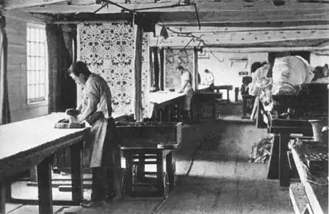 Textiles printed by hand at Merton Abbey (1890).  Carts ran on a track behind the craftsmen, bringing them vats of fresh colours.