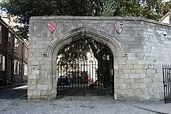 The gate to the lodge, beside Precentor's Court. The shields of arms belong to St Peter and the Deanery of York