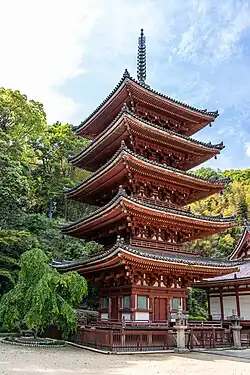 Five-storied pagoda with white walls and red beams.