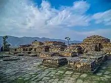 Nemogram Stupa, dating from the Kushan period c. 2-3 centuries CE, with many of its statues on display at the Swat Museum