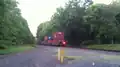 Norfolk Southern westbound train on the Lehigh Line passing through a crossing near Flemington, New Jersey, Picture 4- in back of train part two