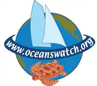 8 tone image of Earth with a banner that reads "OceansWatch" draped over where the equator is. A sea turtle takes up most of the southern hemisphere while two sailboat sails occupy the northern hemisphere.