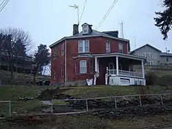 Plain brick house with no decorative features except a modest front veranda. Robert Waugh House, Sparland, Illinois (built in 1886).