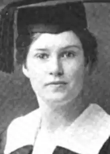 A young white woman wearing a mortarboard cap