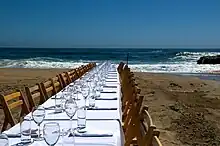 A long white table with places set